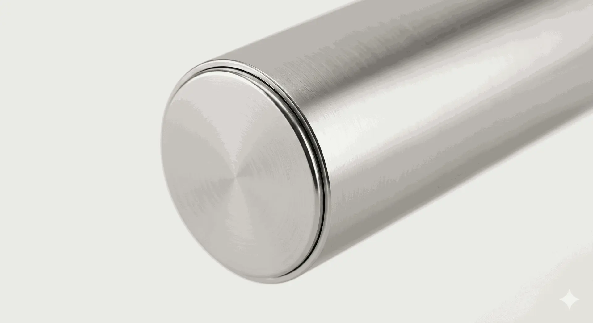 Polished stainless steel flat flush railing end cap inserted into a metal bar rail tube.